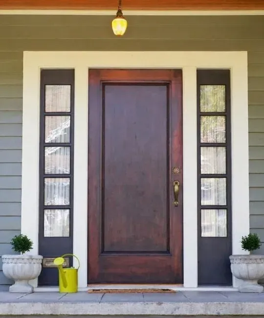 Premium exterior door replacement with elegant wood finish and glass sidelights installed by Pure Windows in a Cincinnati home, ensuring durability, energy efficiency, and enhanced comfort