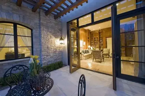 Elegant French patio doors opening from a Cincinnati living room to a stone terrace, installed by Pure Windows to provide classic style, expansive views, and seamless indoor-outdoor flow.