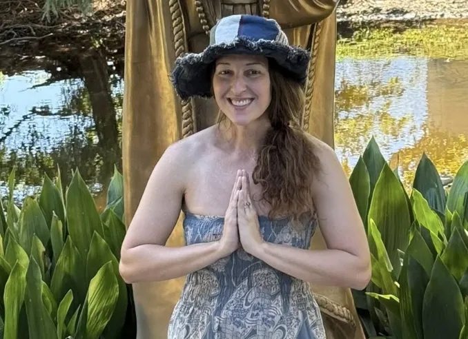 Cori Wise The Holistic Hippie in garden with prayer hands