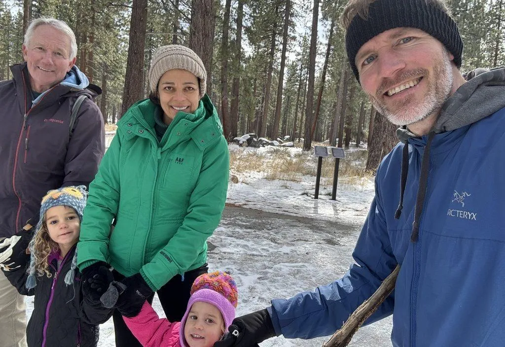 Jared and his father, wife and two young girls walking outside
