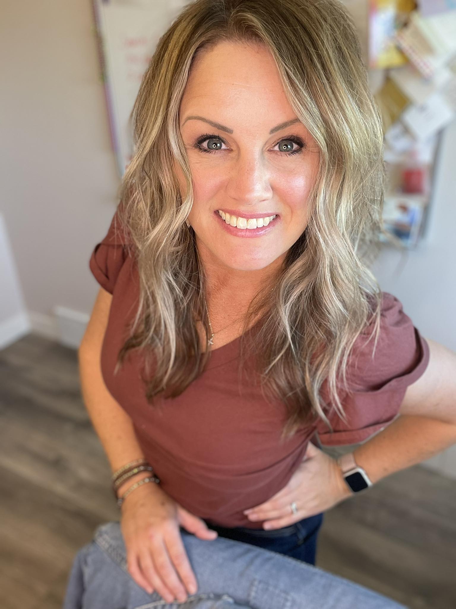 Female entrepreneur drafting captions on a laptop in a bright home office