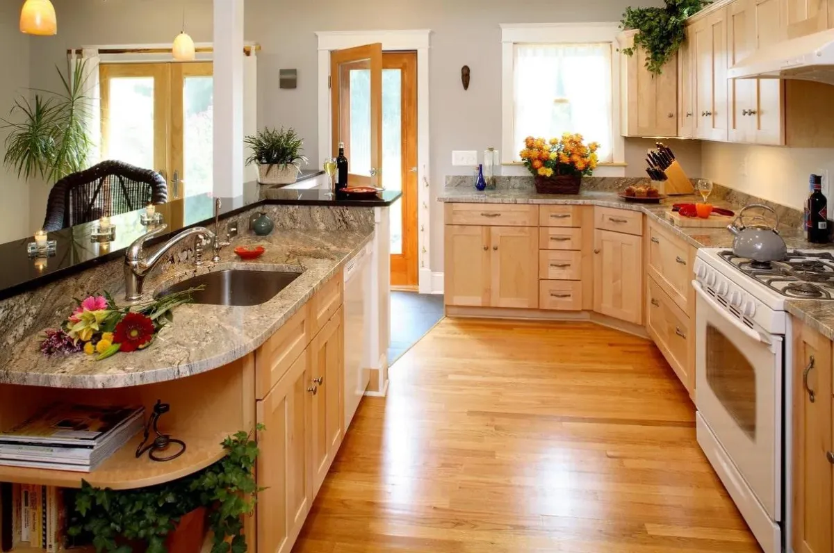a kitchen with granite counter tops and a wood floor