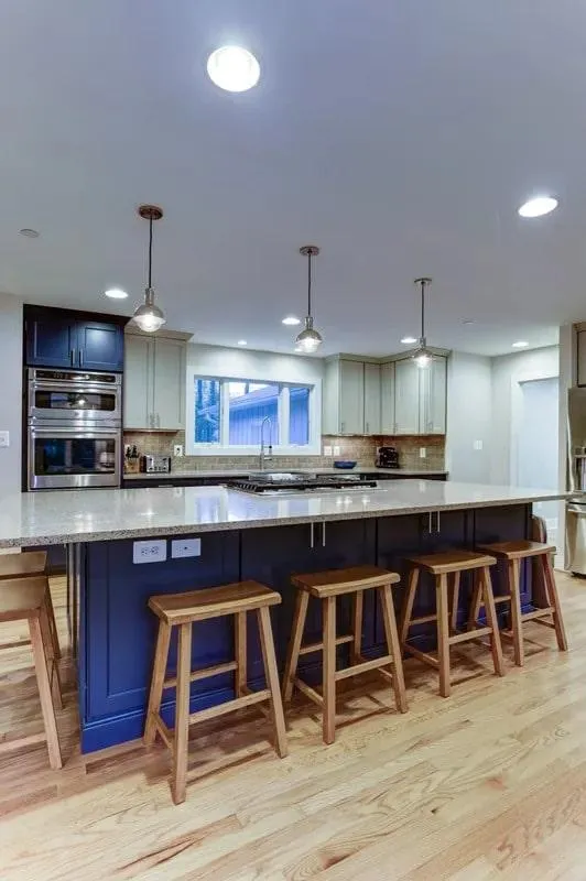 a kitchen with a large island and stools