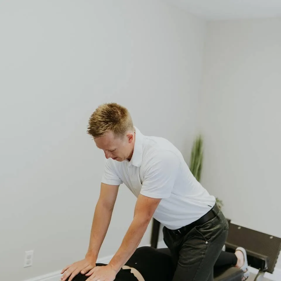 Dr. Brett Grand Performing physical therapy for chiropractic patient.