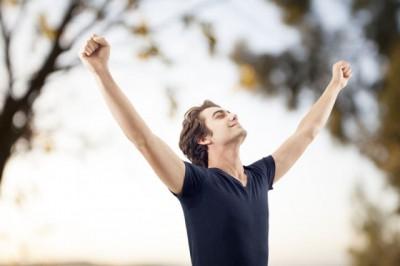 Young man spreading arms in nature