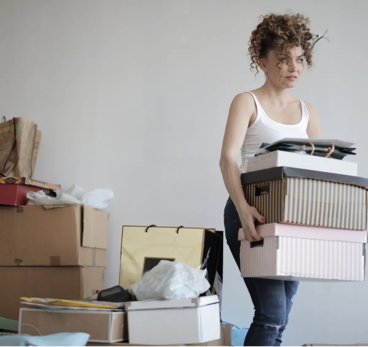 A woman lifting boxes in a room, showcasing her determination and the organized space around her.