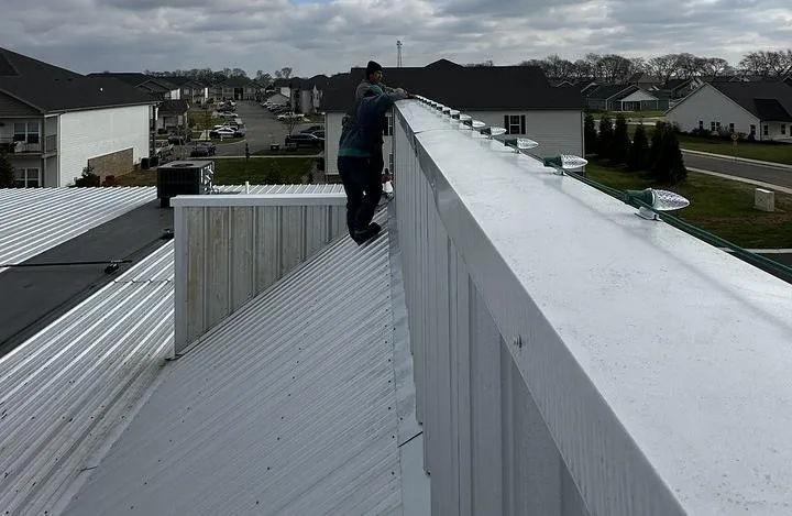 A member of AG Holiday lighting installing lights on a business in Clarksville Tennessee