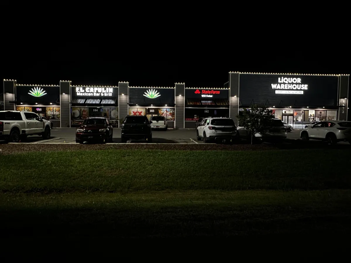 A member of AG Holiday lighting installing lights on a business in Clarksville Tennessee
