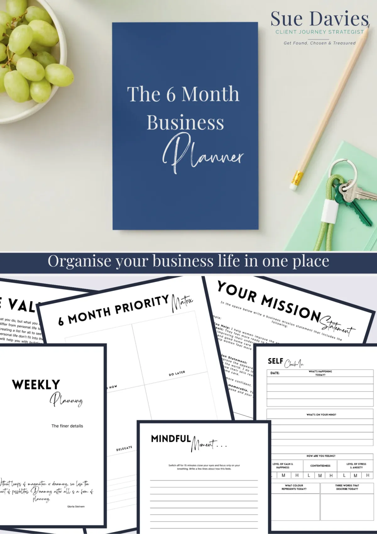Image of 6 month business planner from Sue Davies. Navy blue a4 planner on a desk with a bowl of fruit a pencil, a notebook and Sue Davies Client Journey Strategist in top corner with legend Found Chosen Treasured
