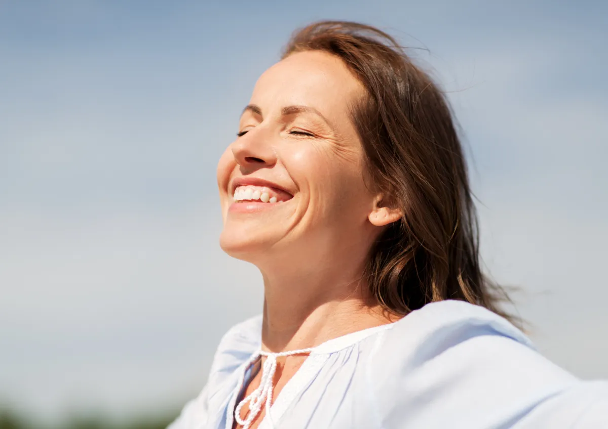 Woman smiling and feeling free and unburdened