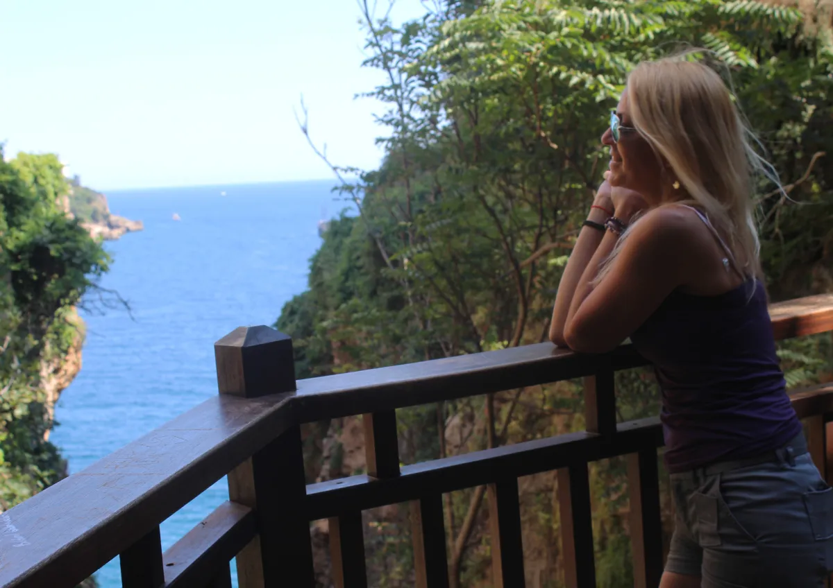 Confident woman looking out to sea from balcony