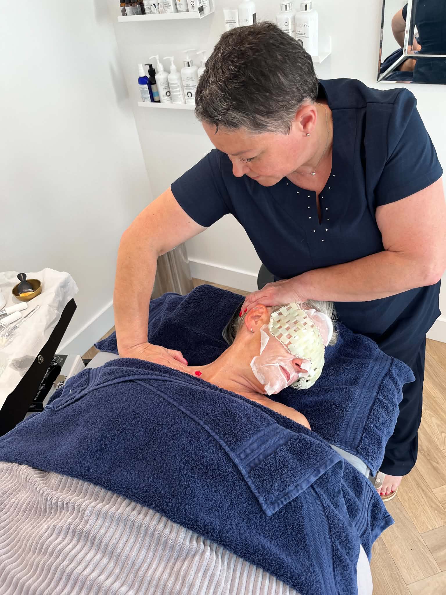Sue Davies owner of Pause - Mind & Body Reset carrying out facial masssage