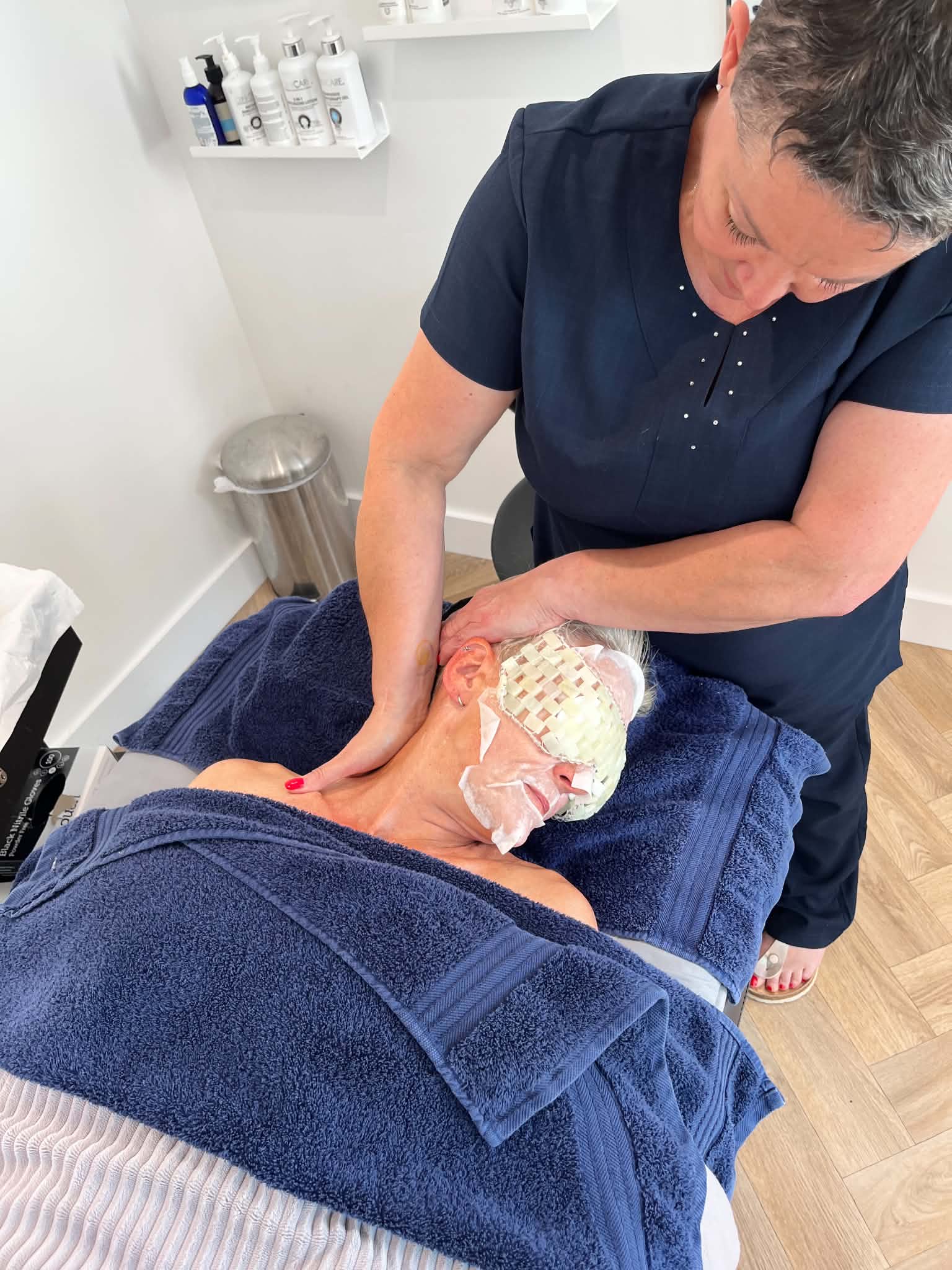 Sue Davies working with a facial client