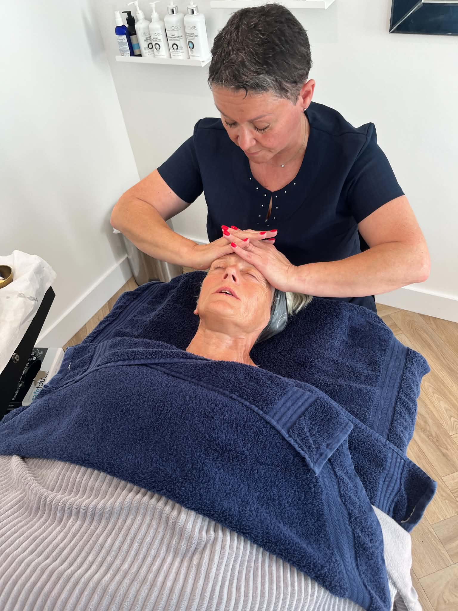 Sue Davies working with a facial client