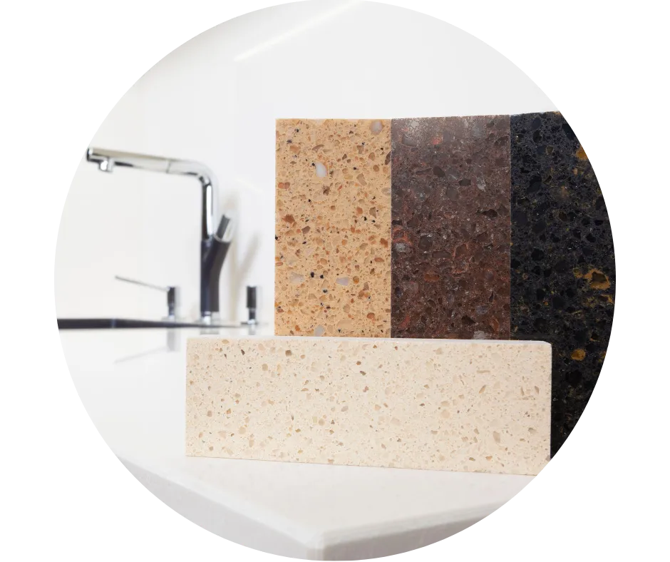 Selection of kitchen worktop material samples beside a modern sink and chrome tap, illustrating options for kitchen upgrades.