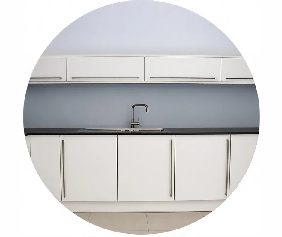 White fitted kitchen with sink, worktops, tiled floor and gloss units installed as part of a staff room kitchen upgrade completed by CDI Contractors