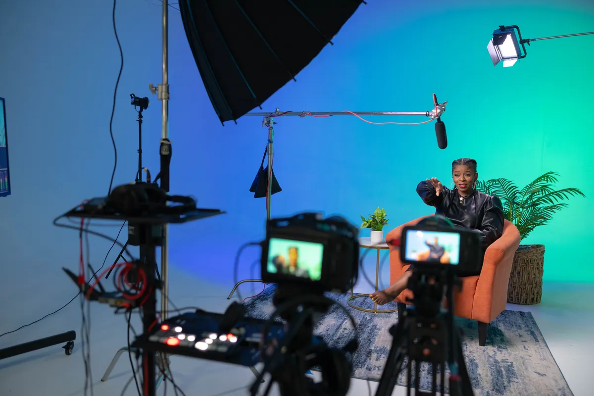 Creator filming a production inside Cr8tive Lyfe Studios with cameras and lighting visible.