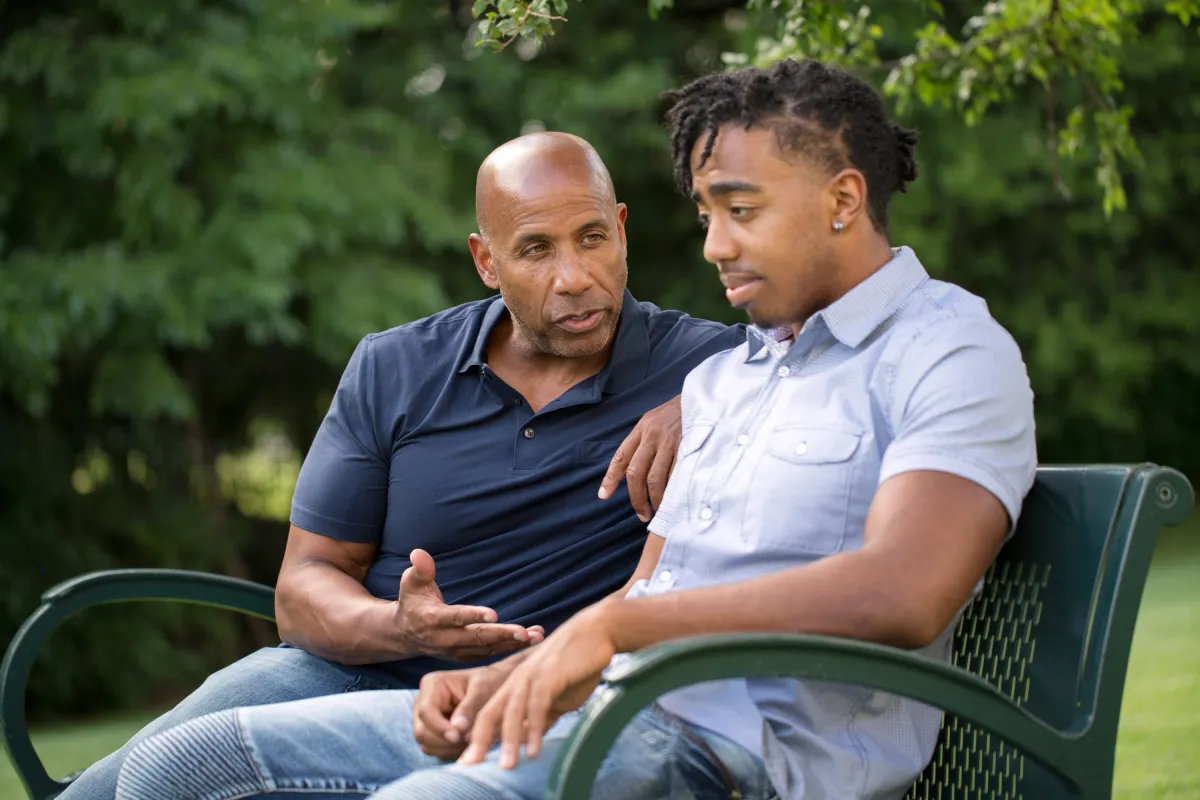a group of three men sitting next to each other