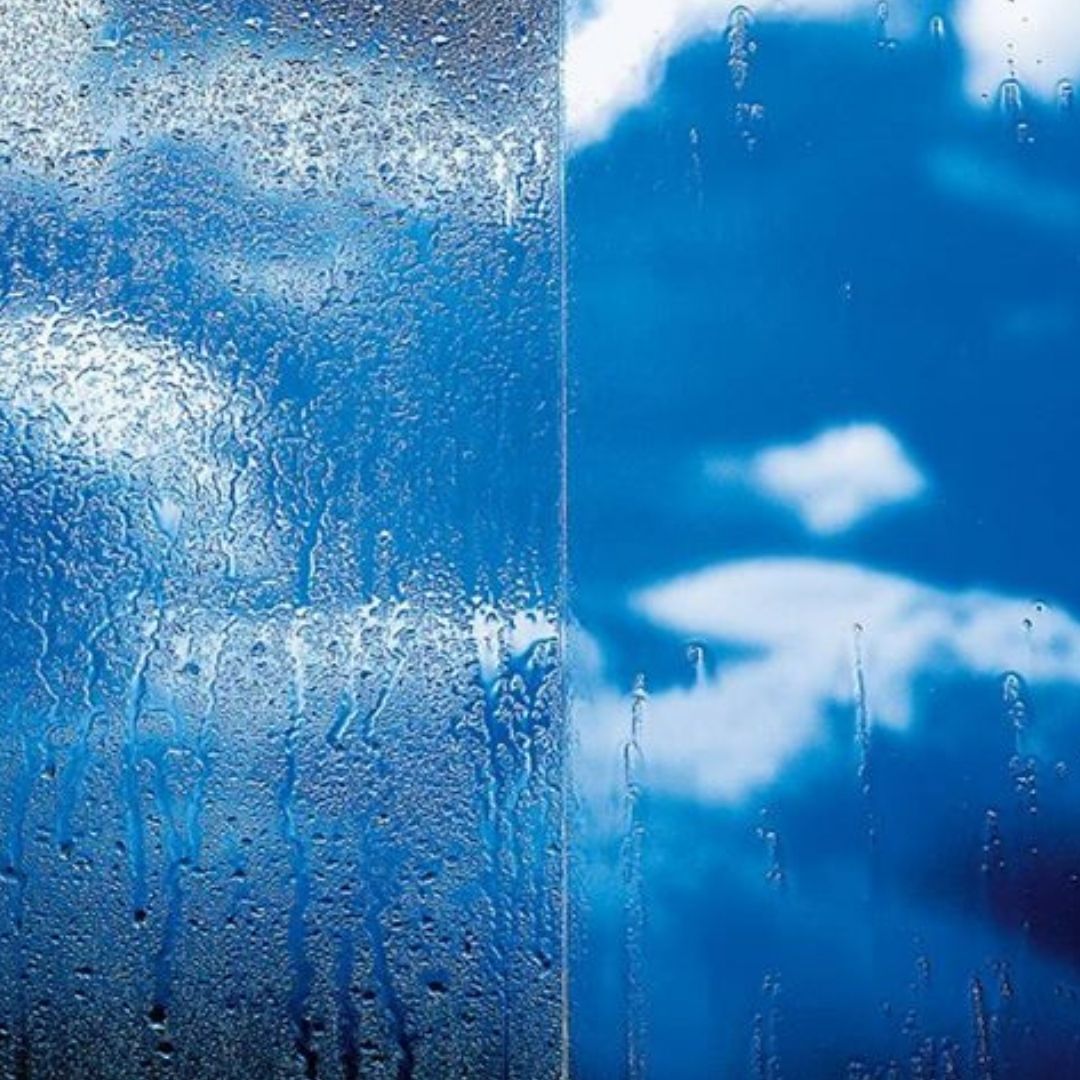 Water beading off nano-coated glass window showing hydrophobic protection