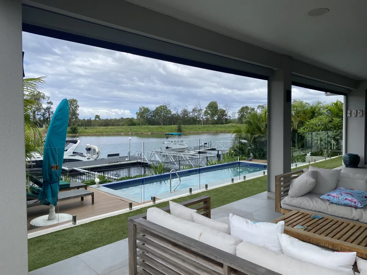 Glass Balustrade window cleaning on a waterfront property in Helensvale