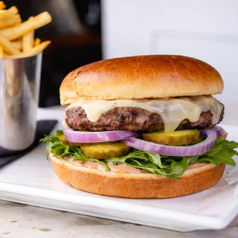 Classic burger with lettuce tomato onion pickle and American cheese at Easy Like Sunday Greensboro NC