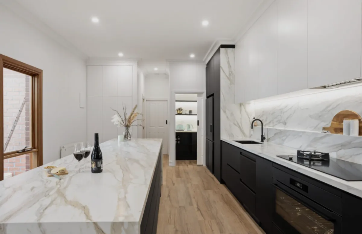 A kitchen with a center island and a refrigerator