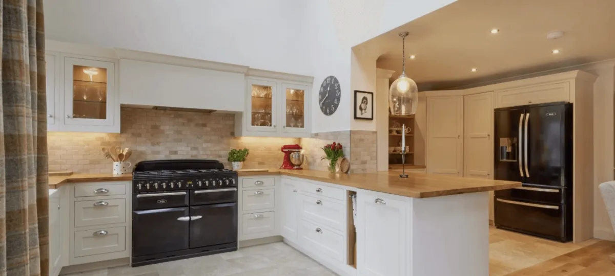 a modern kitchen with a bar and stools