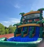 Blue and Green Bouncy house with integrated slide and pool