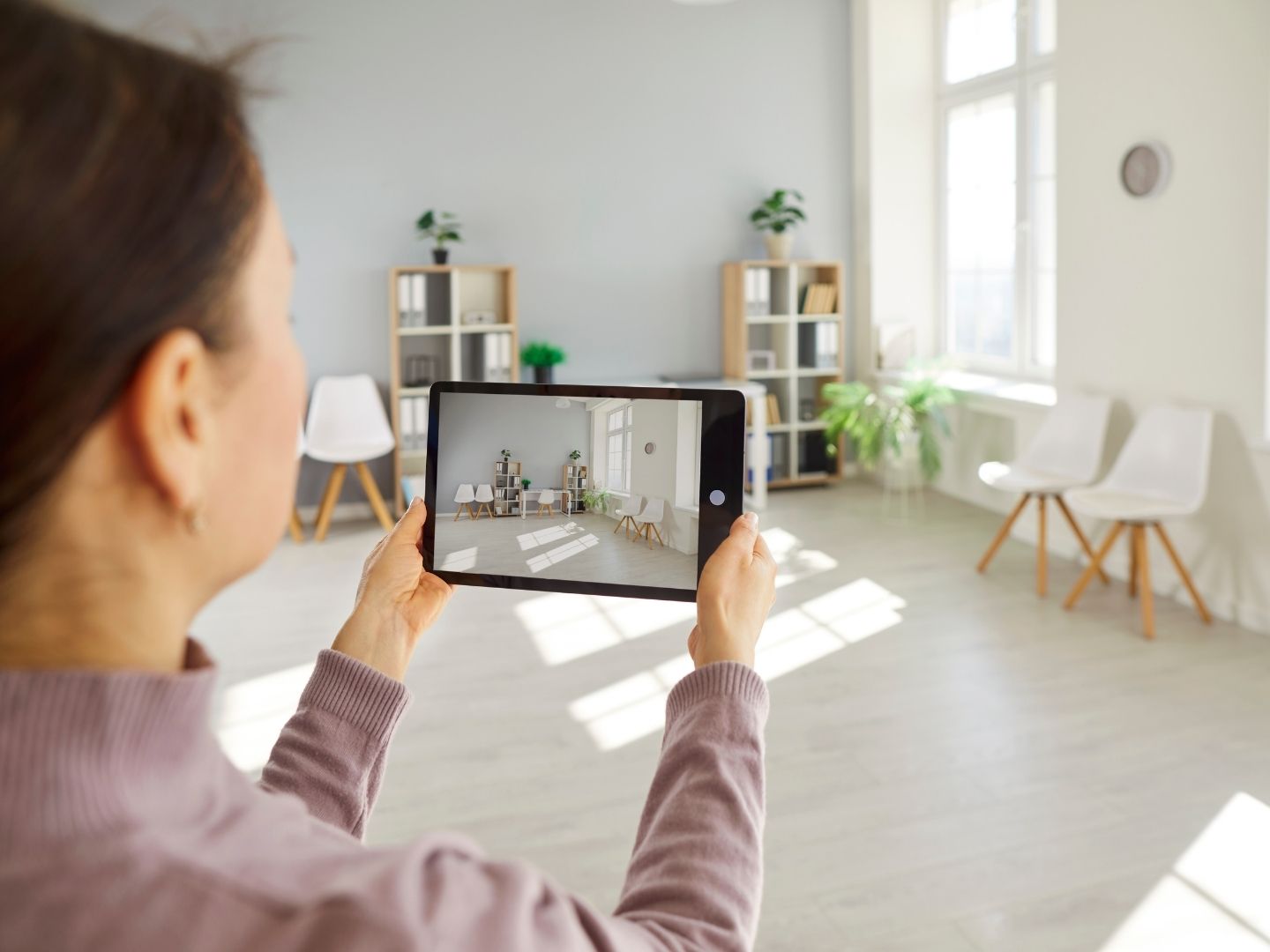 Professional inventory clerk photographing property condition for detailed check-in report in Essex