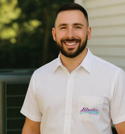 Atlantic Refrigeration technician repairing outdoor air conditioning unit at a Delaware