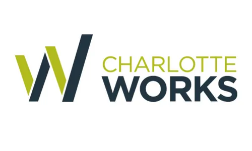 The logo for Charlotte Works. A black and green 3D W.