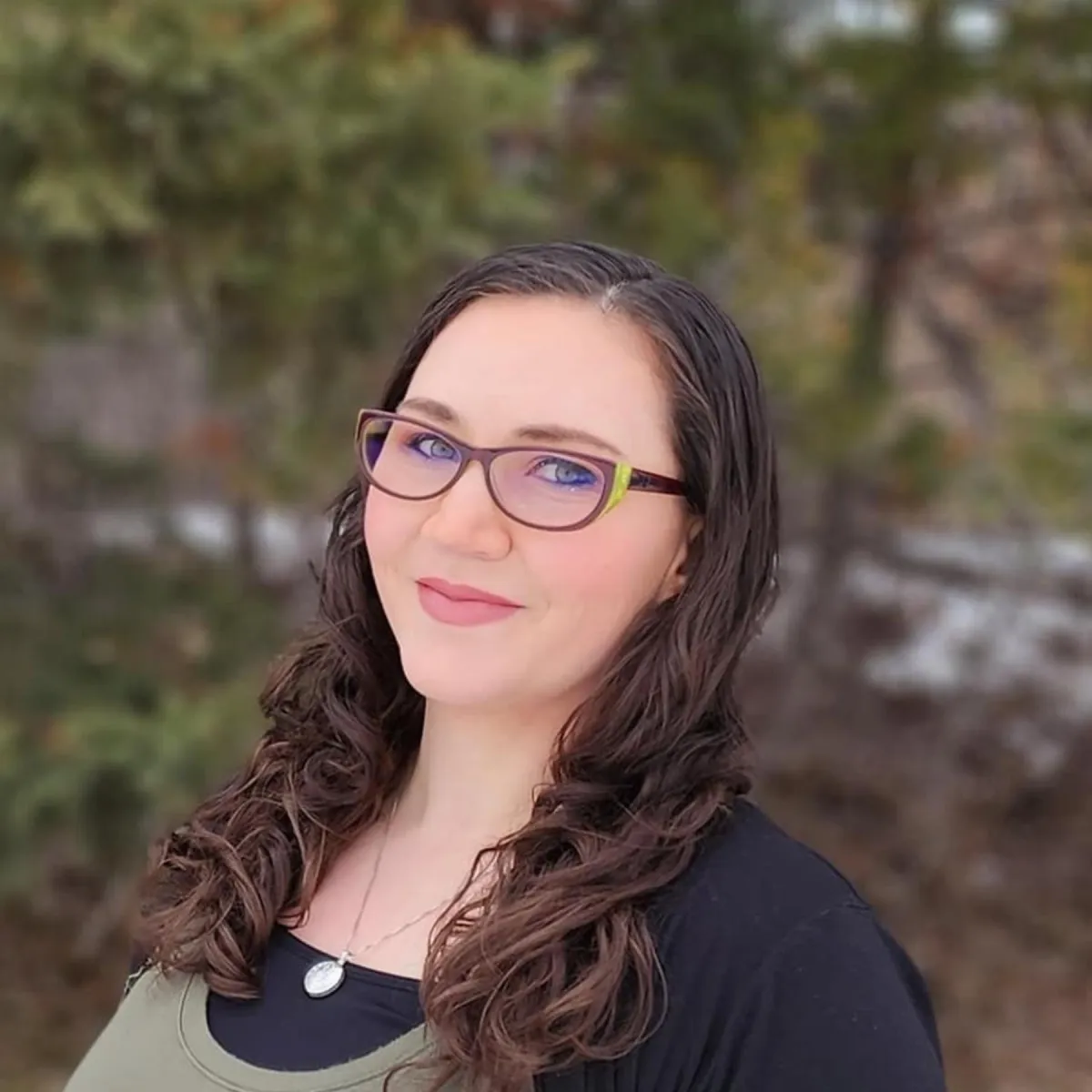 A woman in a green shirt and glasses, identified as Emily Shetterly, Admin at Utah Heating and Air Conditioning Service.