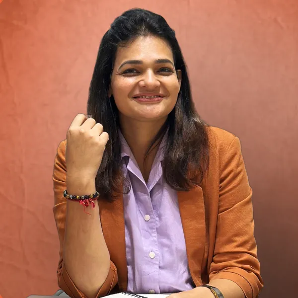 A confident woman entrepreneur in a pastel-toned modern workspace, smiling as she reviews her digital business dashboard on a sleek laptop. Soft, blurred luxury decor conveys calm and empowerment.