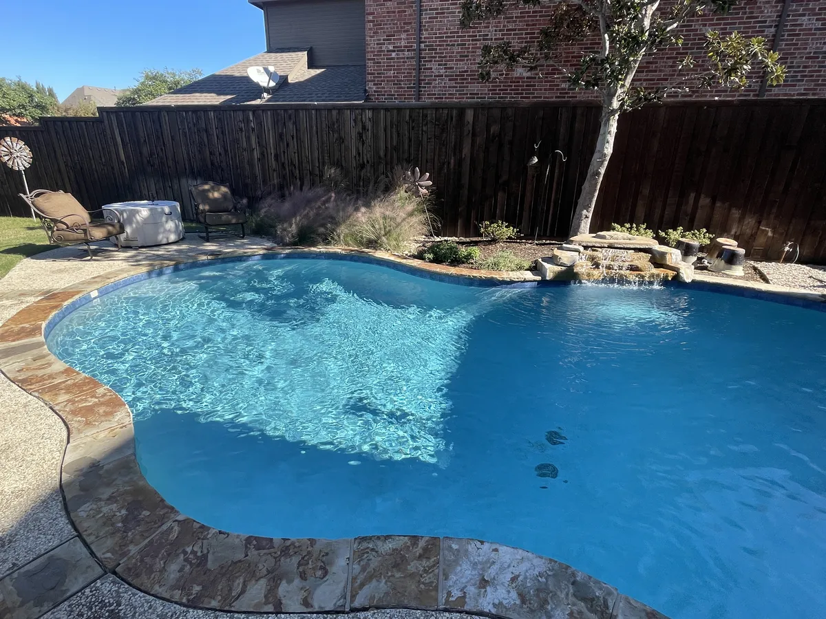 Technician working on a pool pump in a light backyard setting