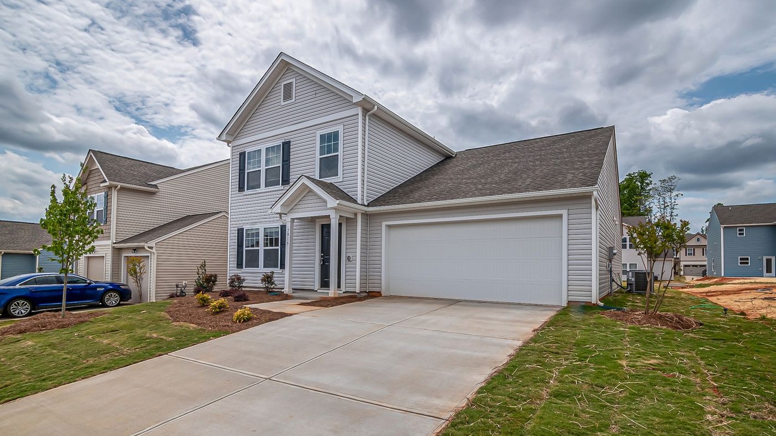 Single-family home with an attached two-car garage and wide driveway, a common ADU candidate lot