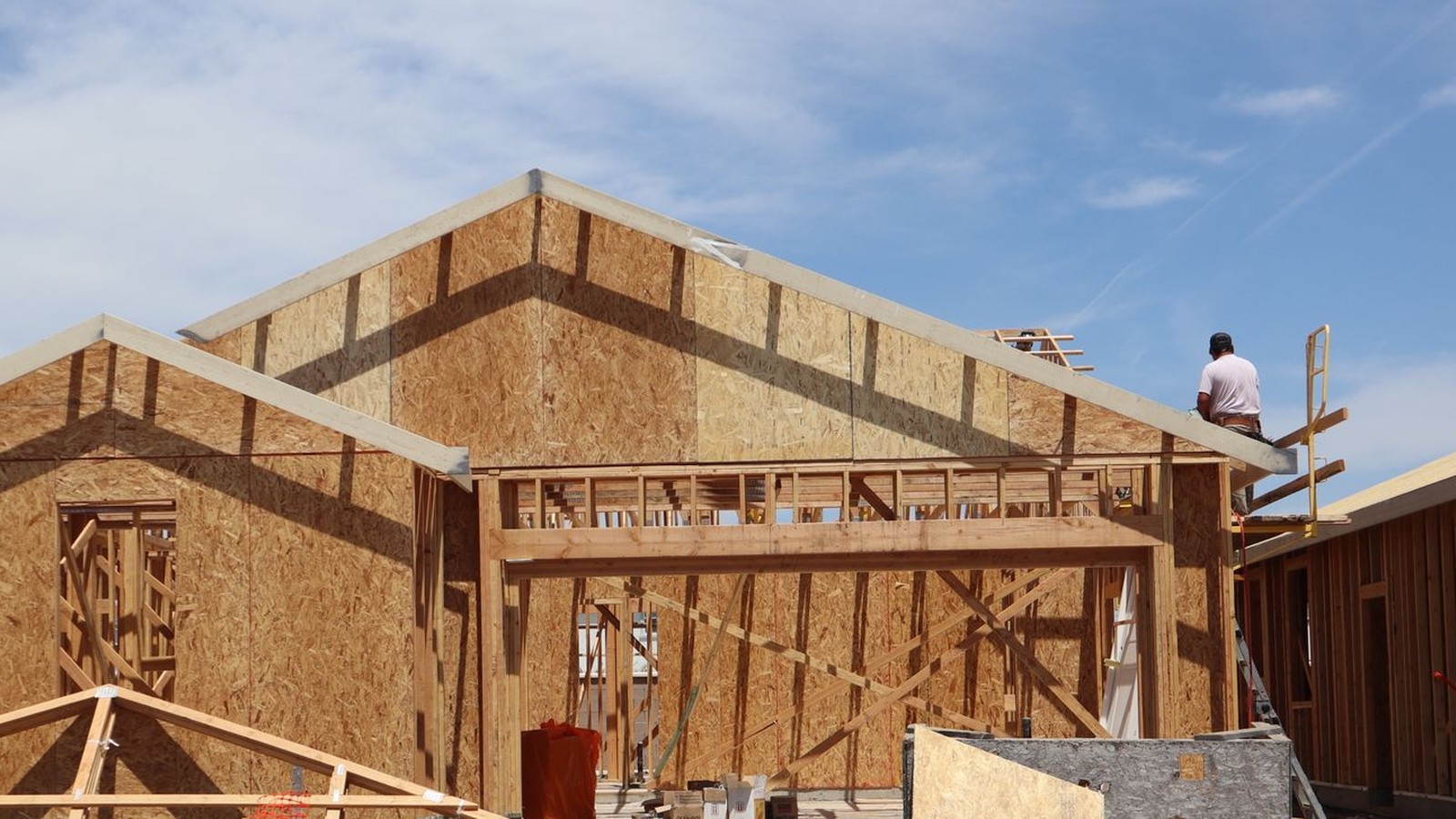 New residential wood framing under construction on a sunny California lot
