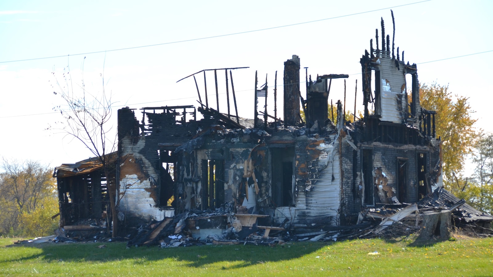 Fire-damaged home with charred framing awaiting documentation and restoration
