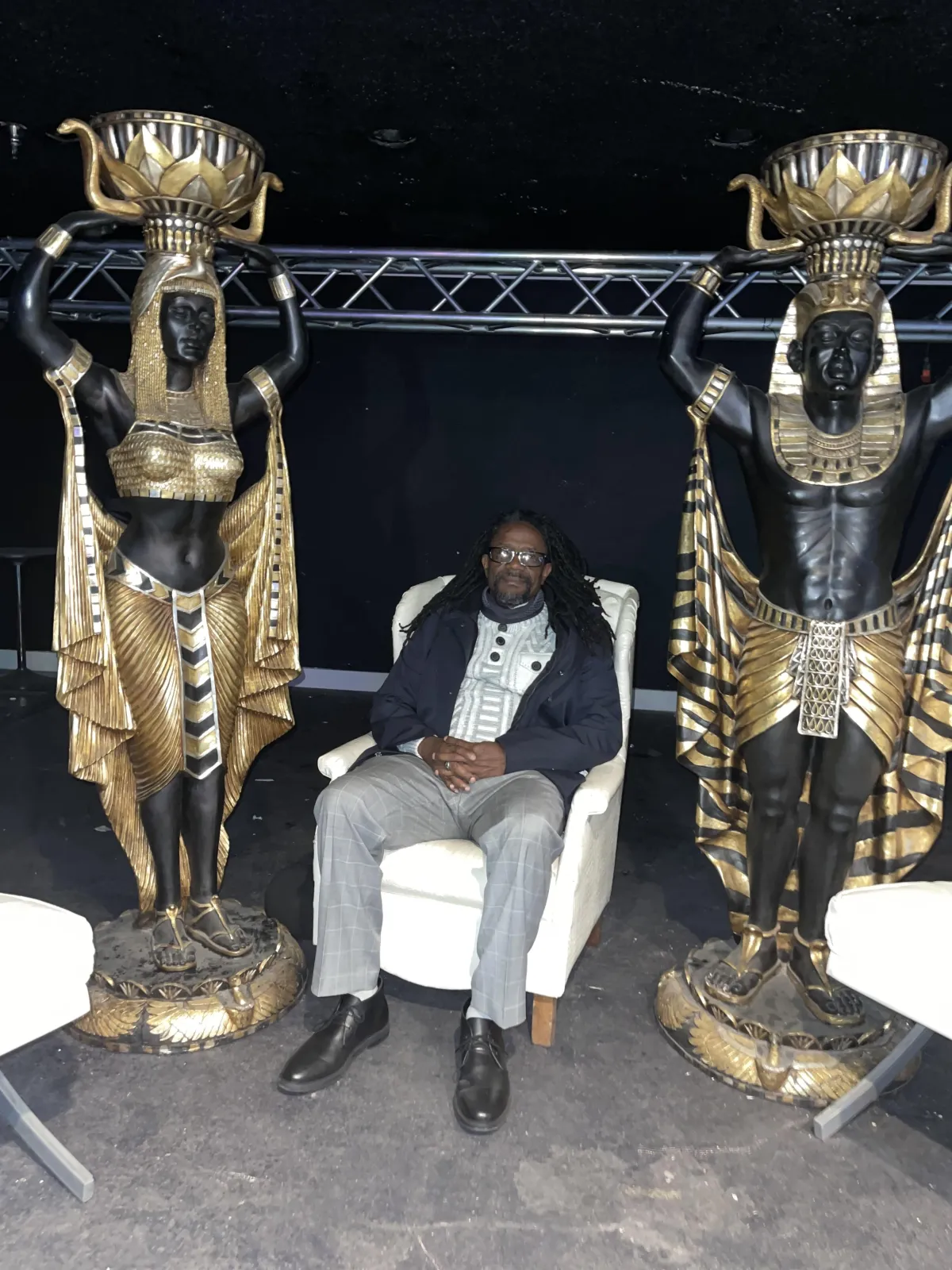 A diverse team of luxury concierges in elegant attire, gathered in a modern, sunlit Las Vegas office. The group exudes professionalism and warmth, with gold accents and contemporary decor, highlighting a collaborative, high-end service environment. Aspect ratio 3:2.