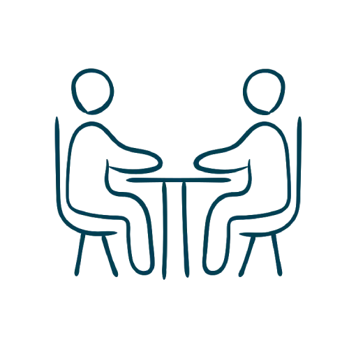 Icon of two people seated at a table representing a consultation or one-on-one meeting