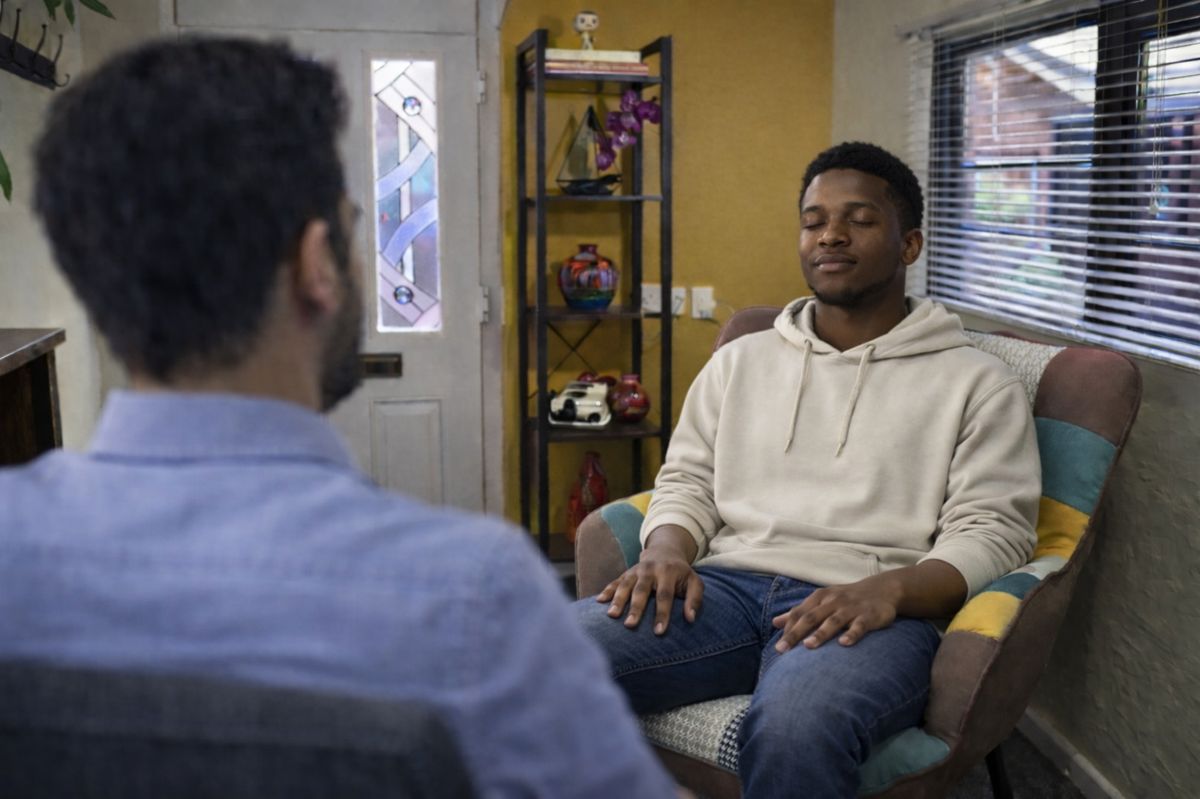Man eyes closed relaxed in hypnotherapy session