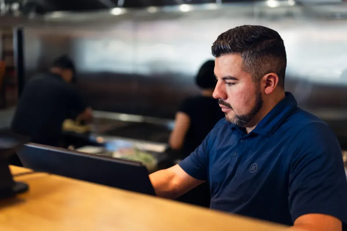 Daniel, the owner of Top Taco Restaurant, providing friendly service at the cashier counter in Salt Lake City, Utah. Experience authentic Mexican hospitality and the best street tacos in town at our local taqueria