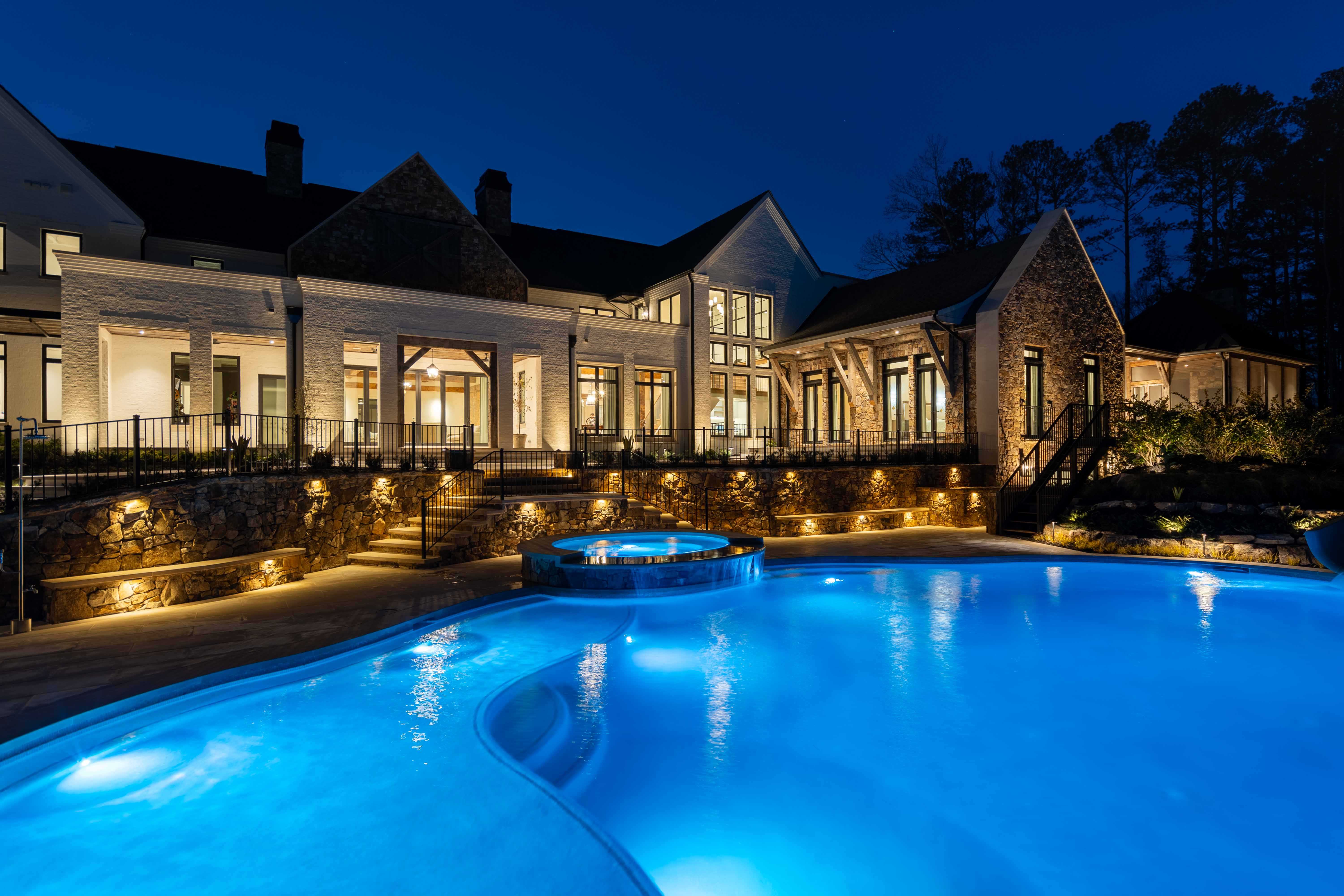 Real twilight real estate photography showing luxury home exterior lighting and pool at sunset in Buckhead