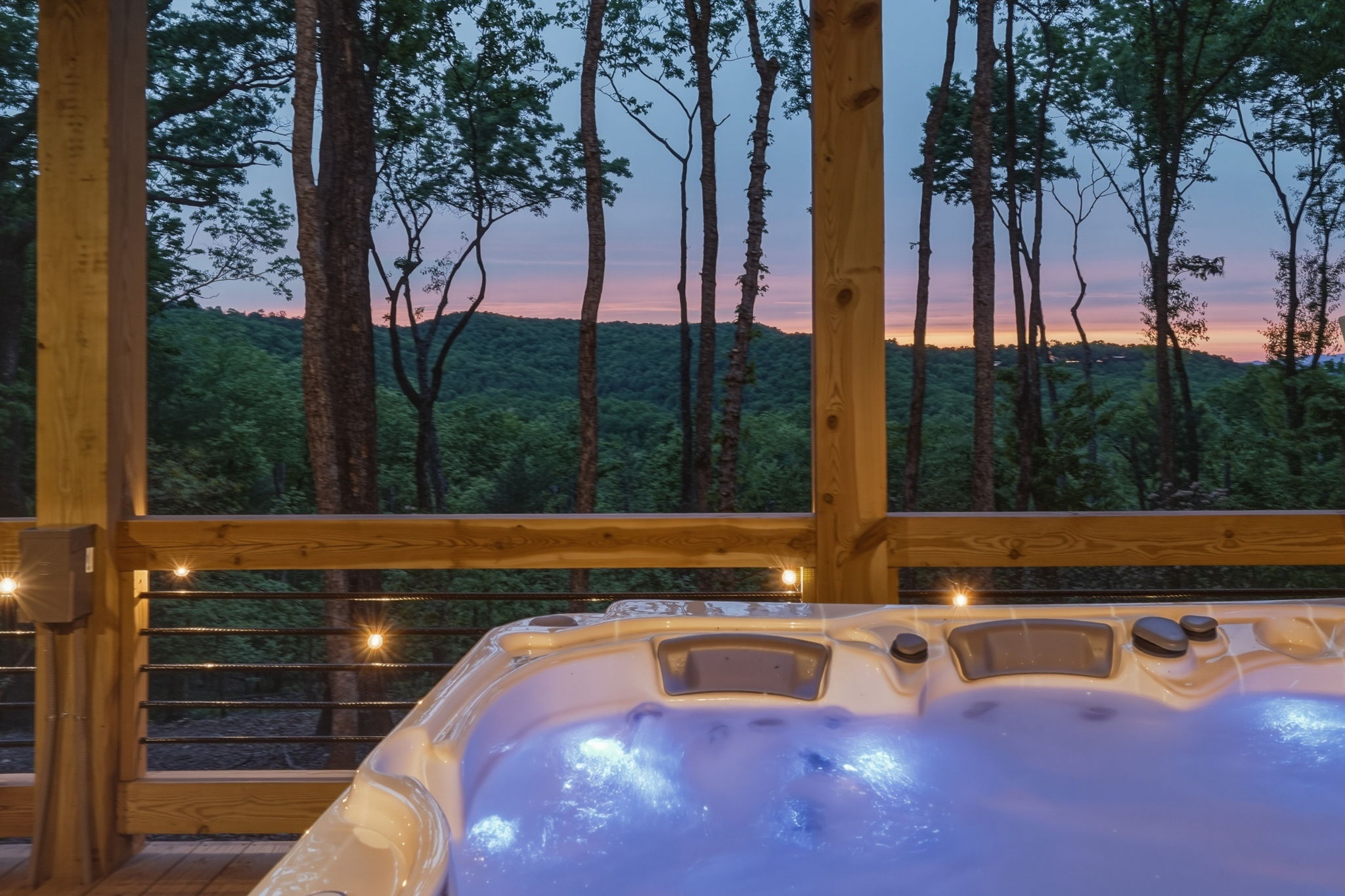 Hot tub, pool, and exterior lighting turned on for professional real estate photography