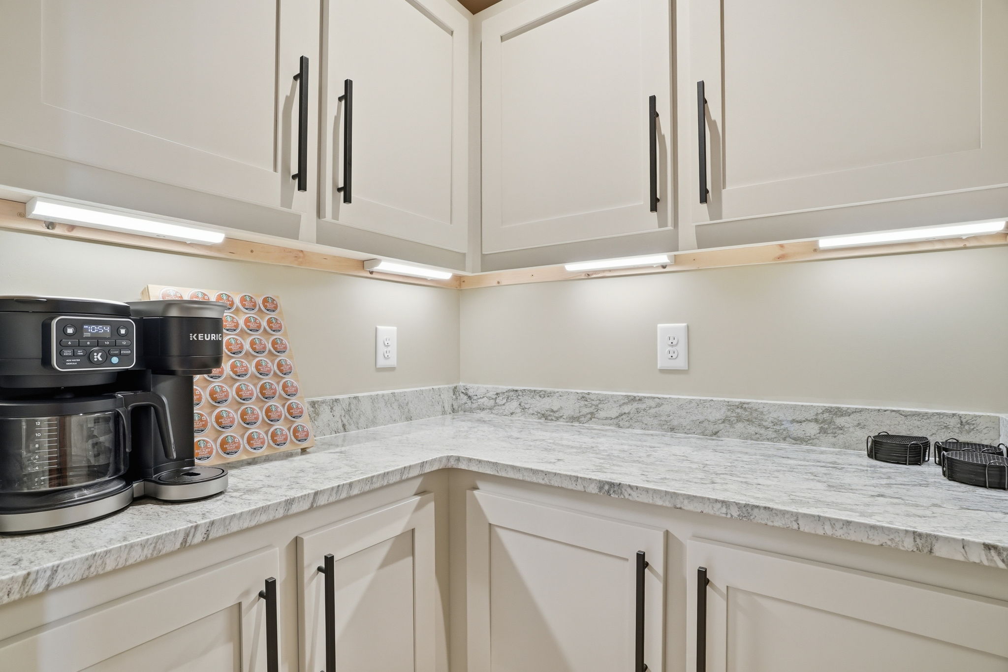 Clean kitchen countertops with under cabinet lighting ready for professional real estate photography