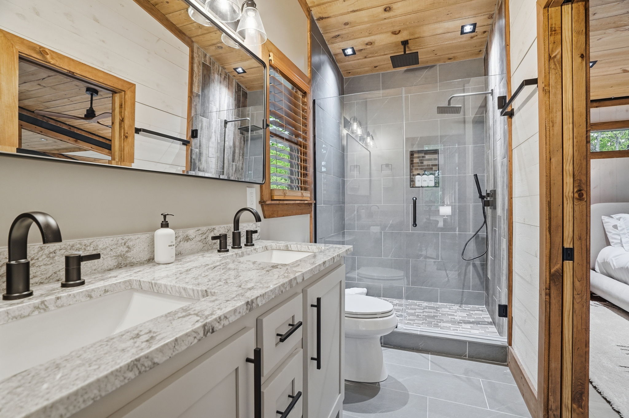 Clean bathroom countertops, mirrors, and shower areas prepared for professional real estate photography