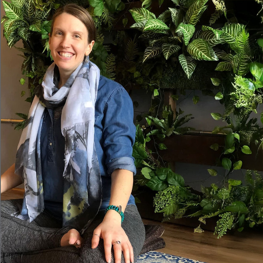smiling women next to green wall