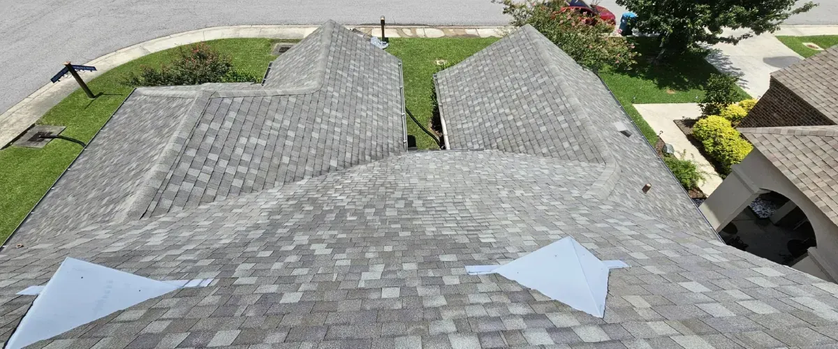 Top-down view of a well-maintained and clean residential roof with evenly installed shingles.