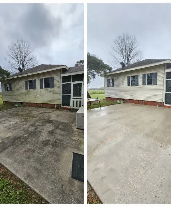 Before and after pressure washing a house siding and driveway, restoring surfaces to a clean and fresh appearance.