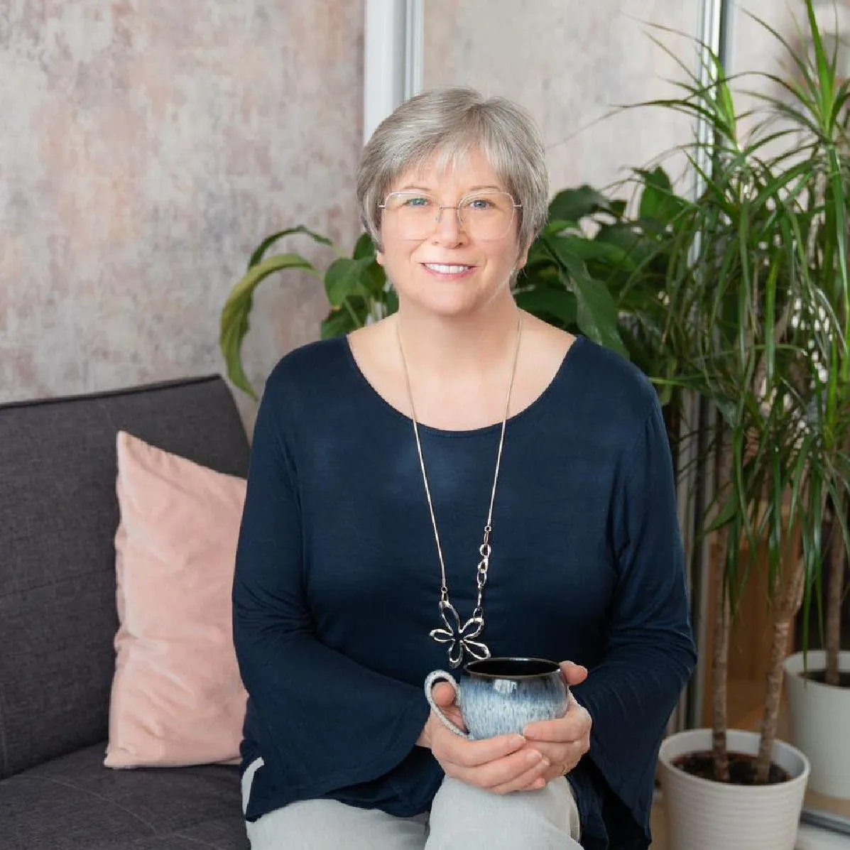 Image of Suzanne Smith, seated with cup of tea