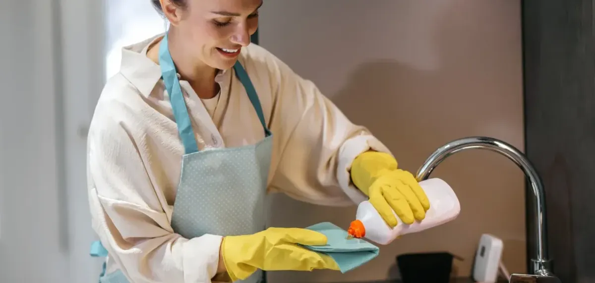 Woman applying soap to towel for cleaning